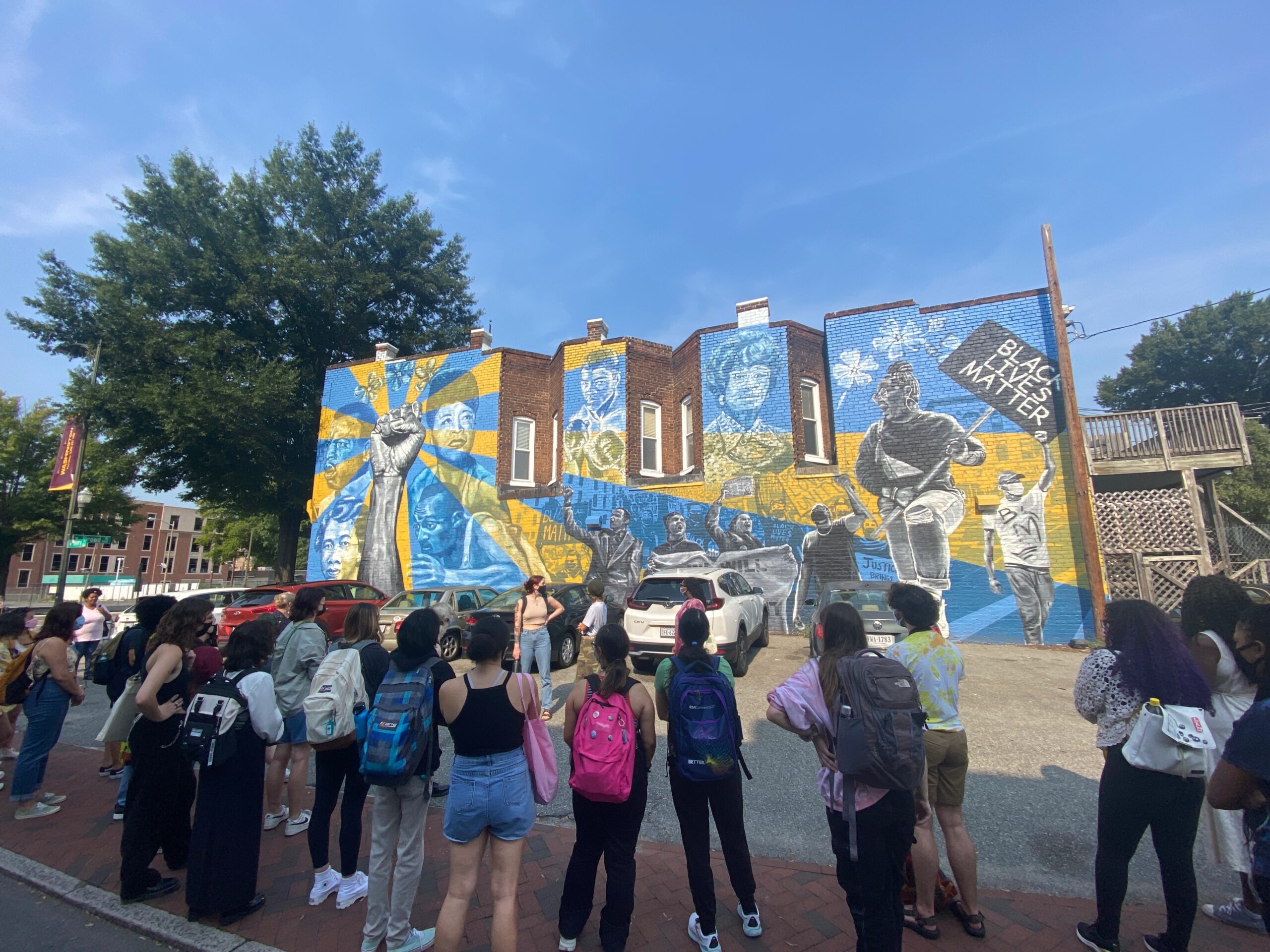 Preservice art education students discuss a Mending Walls mural, Voices of Perseverance, by Richmond, VA artists Jason Ford & Ed Trask. Image credit Caitlin Black.